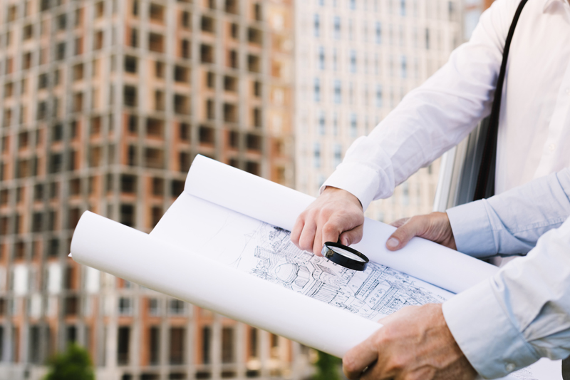 close-up-people-holding-building-sketch